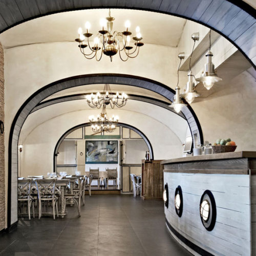 Boat style bar with classic chandeliers and framed arches