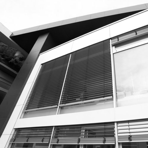 Close look to black and white facade with shutters