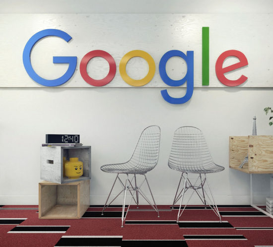 Two metal chairs and wooden boxes in front of the white wall with company logo