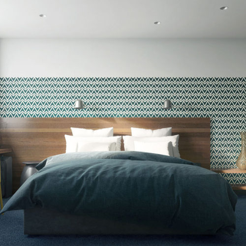 Double bed with natural wood header and patern wallpaper