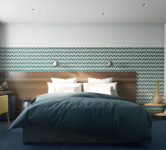 Double bed with natural wood header and patern wallpaper