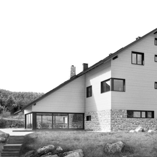 Side view of modern mountain social center with wooden facade